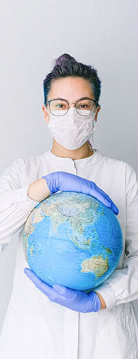 Nurse in surgical mask holding a globe